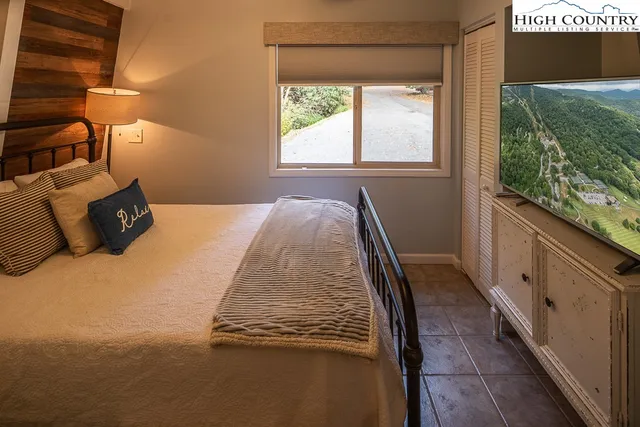 a bed sitting in a bedroom next to a window