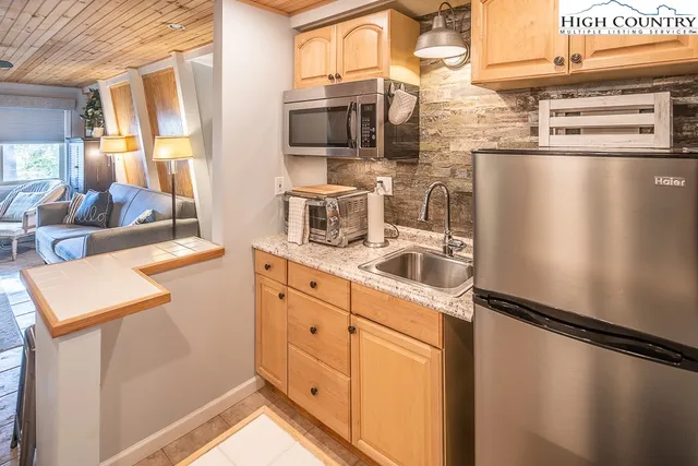 a view of a porch with furniture and wooden floor