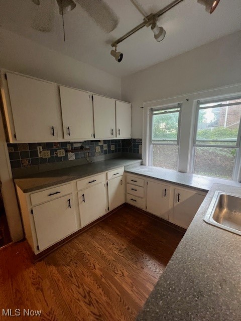 2915 Ludlow Road Cleveland, OH 44120 - Photo 16 of 50 Kitchen featuring white cabinetry, dark wood finished floors, and tasteful backsplash