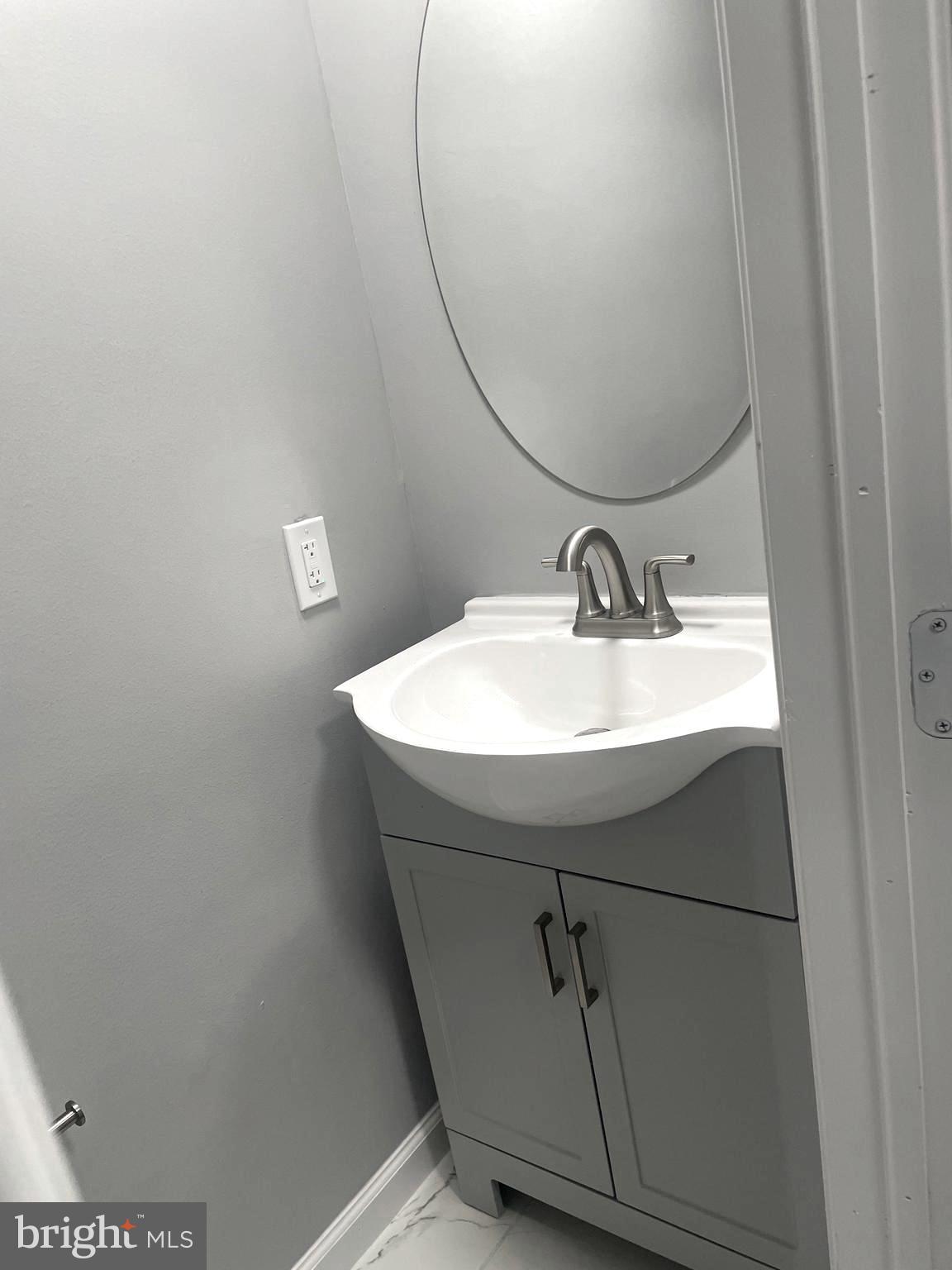 6107 Buckler Road Clinton, MD 20735 - Photo 15 of 45 a bathroom with a sink and mirror