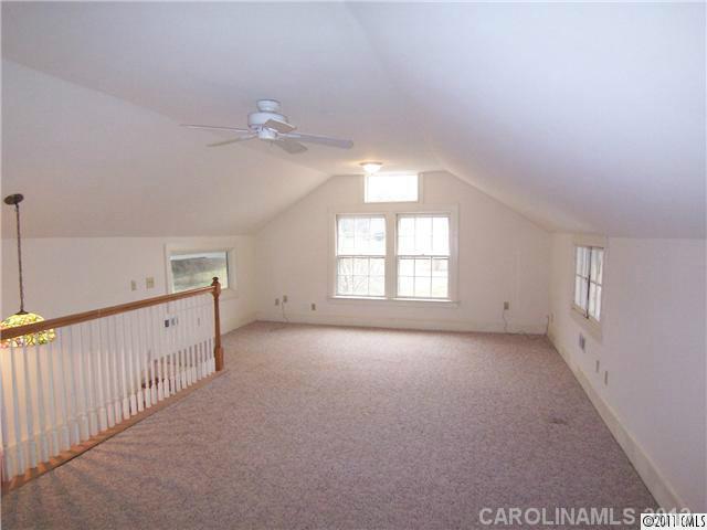 2717 Toddville Road Charlotte, NC 28214 - Photo 11 of 11 an empty room with windows and fan