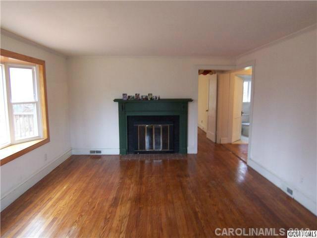 2717 Toddville Road Charlotte, NC 28214 - Photo 5 of 11 a view of an empty room with wooden floor and a window