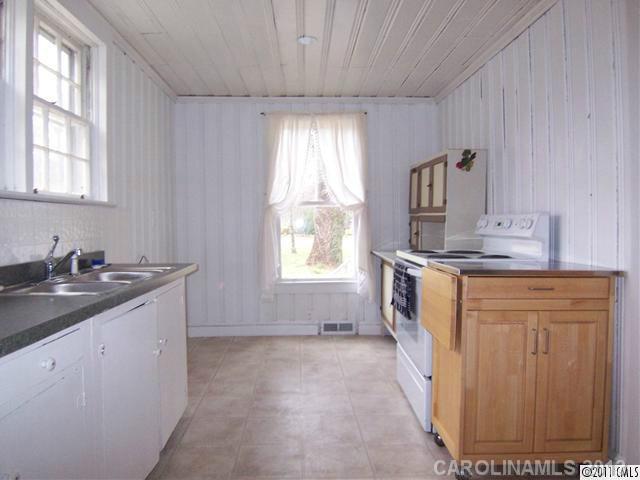 2717 Toddville Road Charlotte, NC 28214 - Photo 7 of 11 a bathroom with a granite countertop sink a window and a mirror