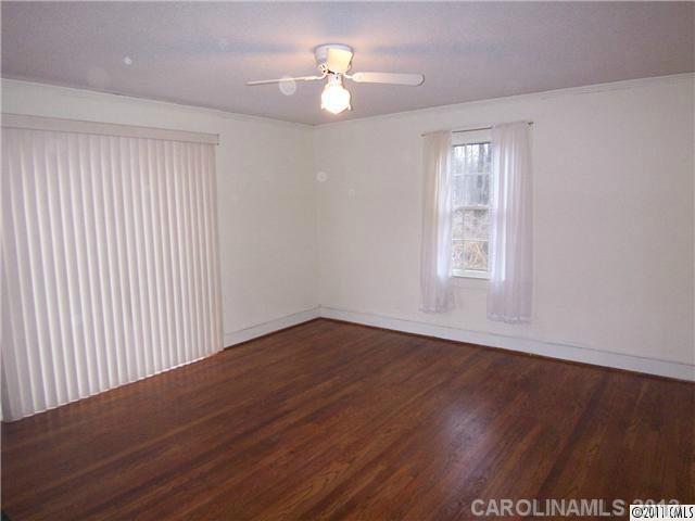 2717 Toddville Road Charlotte, NC 28214 - Photo 8 of 11 wooden floor in an empty room with a window