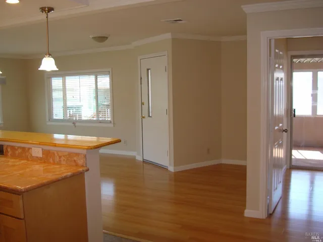 a view of a room with wooden floor and a window