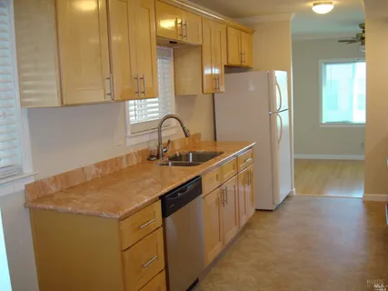 a kitchen with stainless steel appliances a sink stove and refrigerator