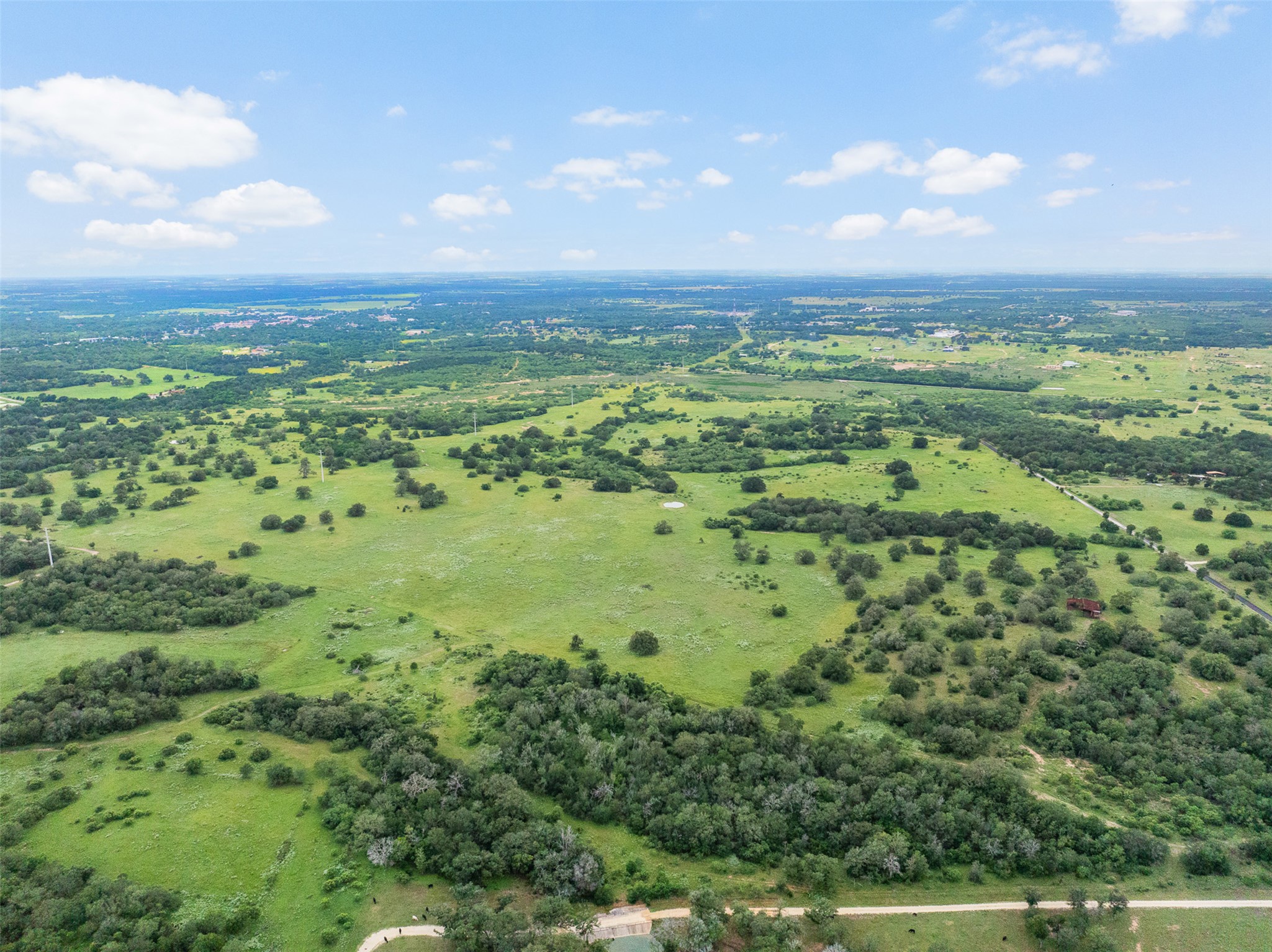 Tbd Lot 10 Tbd Road Luling, TX 78648 - Photo 3 of 10 Vast green acreage punctuated by mature trees offers tranquil pastoral views and endless possibilities.