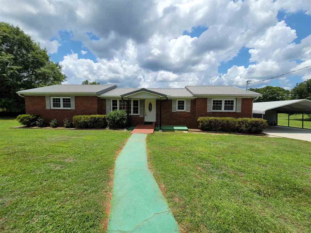 1674 B B Wilson Road Commerce, GA 30529 - Photo 1 of 1 a front view of house with yard and green space