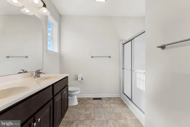 a bathroom with a sink a toilet a mirror and vanity