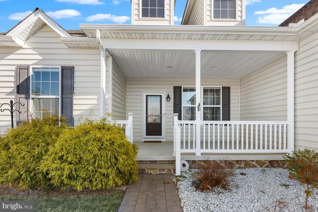 a view of a house with a small yard and wooden floor and fence