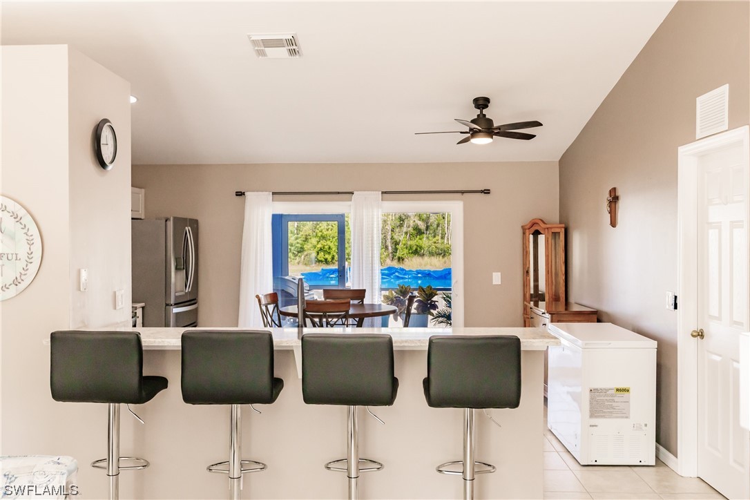 217 Manatee Street Fort Myers, FL 33913 - Photo 11 of 38 a kitchen with a dining table chairs and a chandelier
