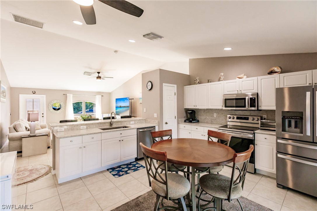 217 Manatee Street Fort Myers, FL 33913 - Photo 14 of 38 a kitchen with stainless steel appliances kitchen island granite countertop a sink and cabinets