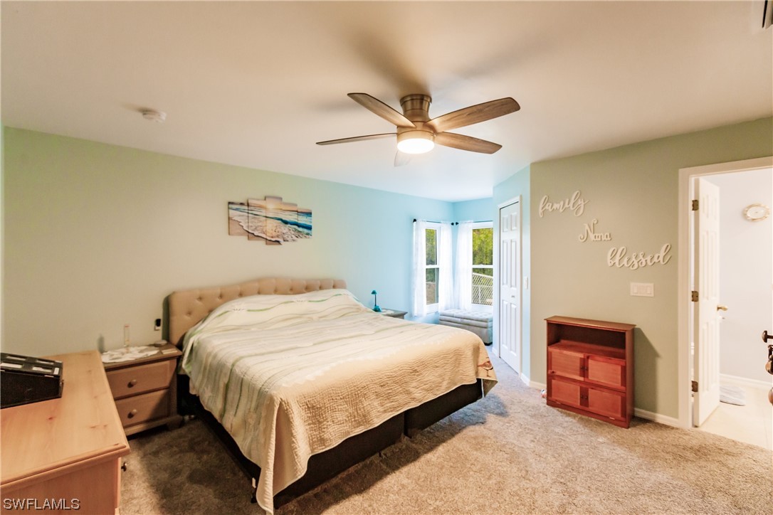 217 Manatee Street Fort Myers, FL 33913 - Photo 17 of 38 a bedroom with a bed and a chandelier