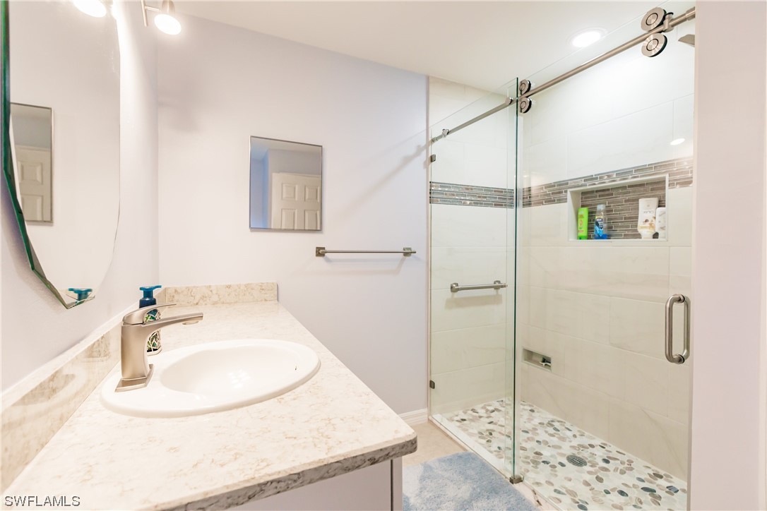 217 Manatee Street Fort Myers, FL 33913 - Photo 21 of 38 a bathroom with a sink and a mirror