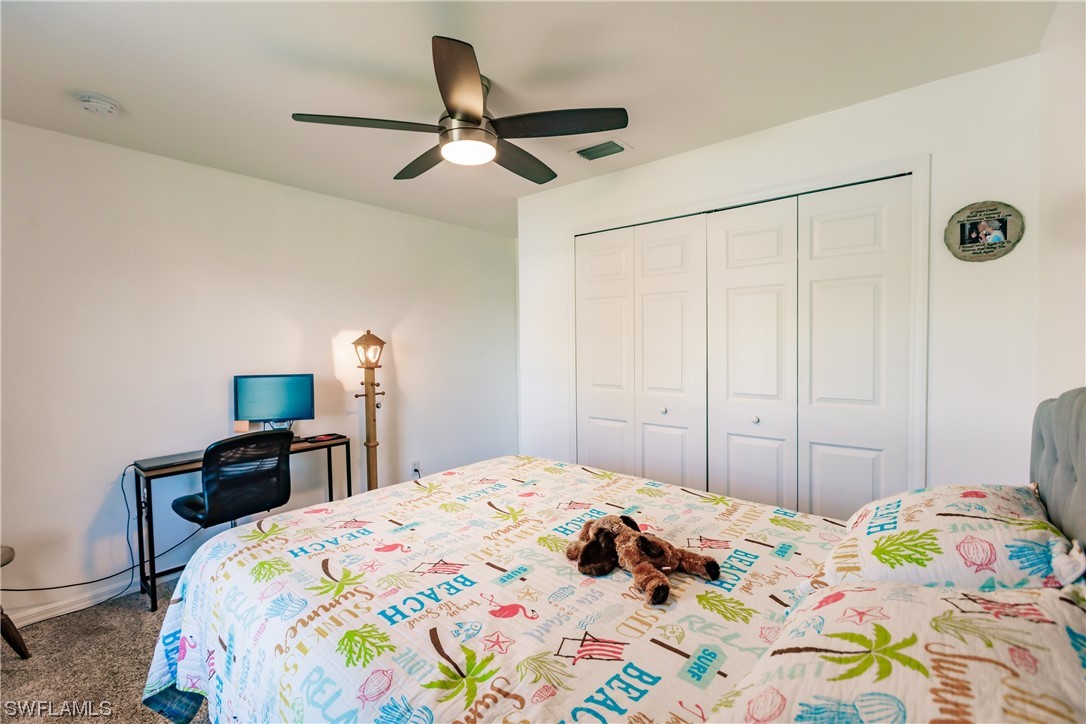 217 Manatee Street Fort Myers, FL 33913 - Photo 26 of 38 a bedroom with a bed and a chandelier