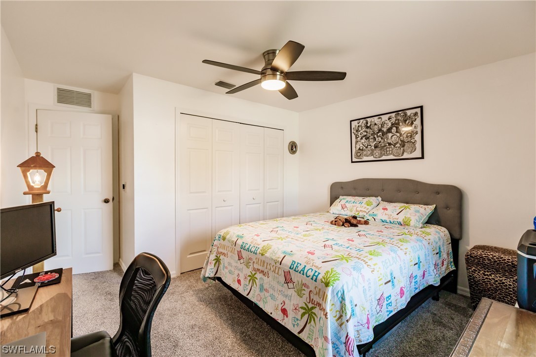 217 Manatee Street Fort Myers, FL 33913 - Photo 27 of 38 a bedroom with a bed and a flat screen tv