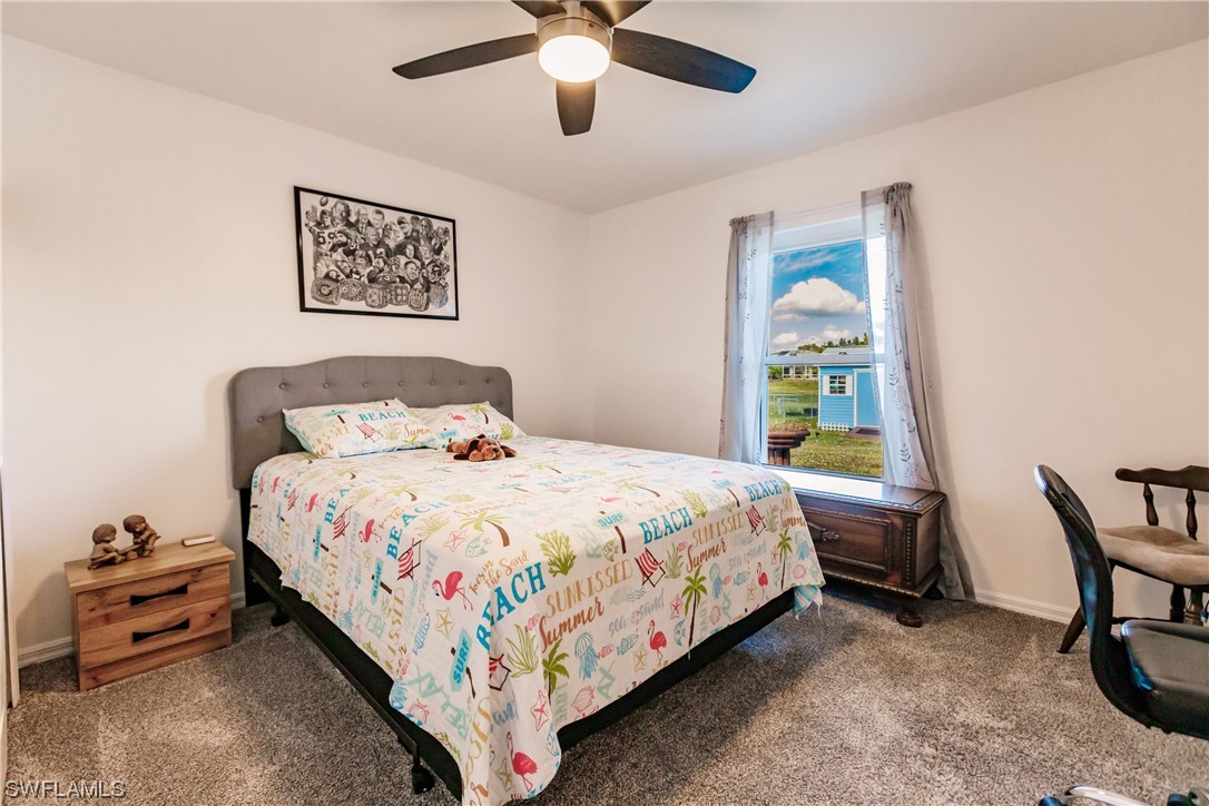 217 Manatee Street Fort Myers, FL 33913 - Photo 28 of 38 a bedroom with a bed and a chandelier