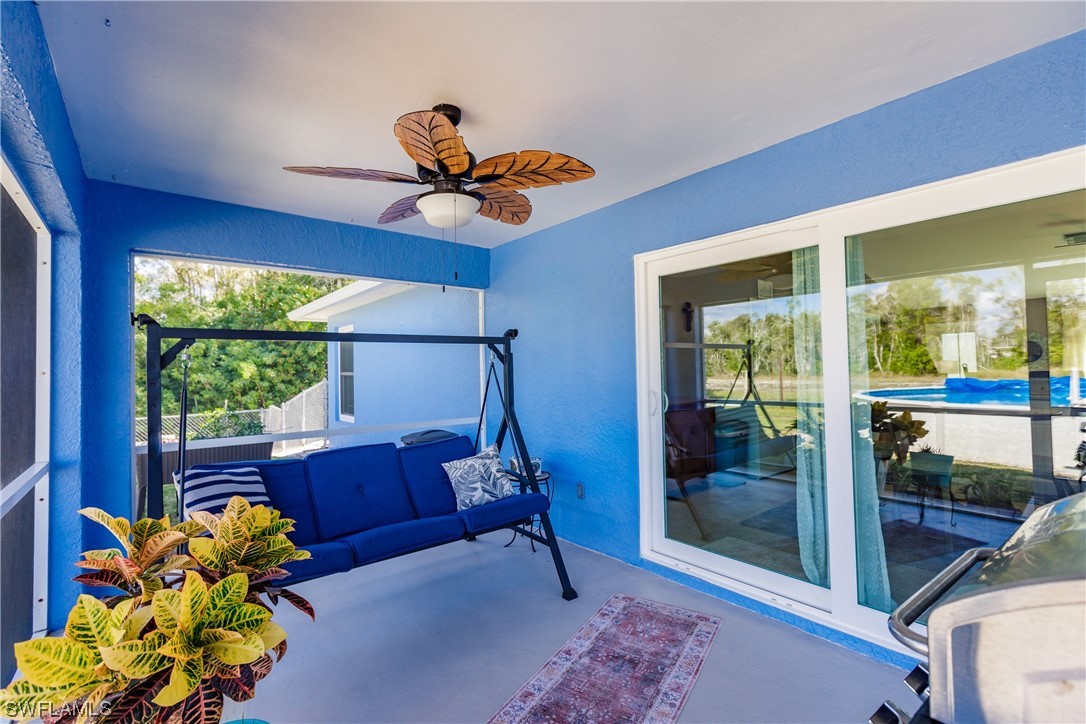 217 Manatee Street Fort Myers, FL 33913 - Photo 32 of 38 a living room with furniture a floor to ceiling window and a potted plant