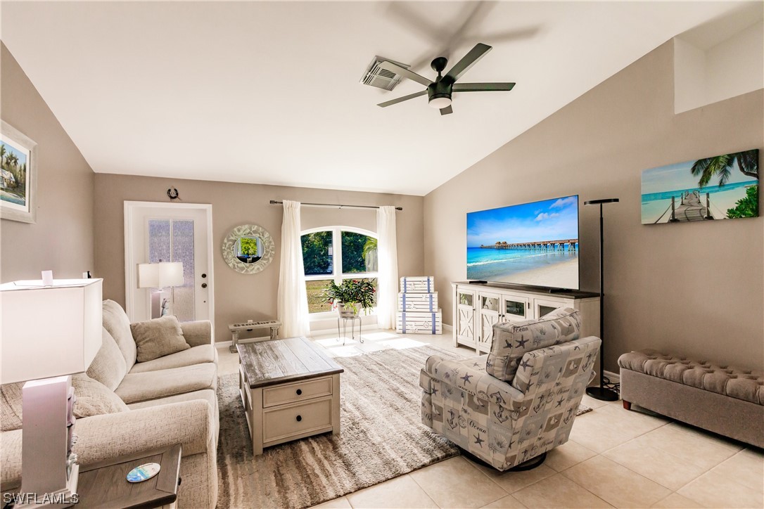 217 Manatee Street Fort Myers, FL 33913 - Photo 10 of 38 a living room with furniture and a flat screen tv