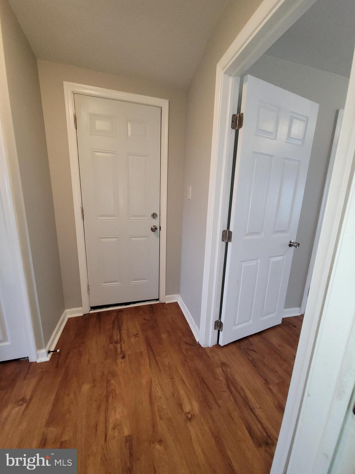 503 North Rodney Street, Unit 3A Wilmington, DE 19805 - Photo 11 of 18 an empty room with wooden floor and a gate