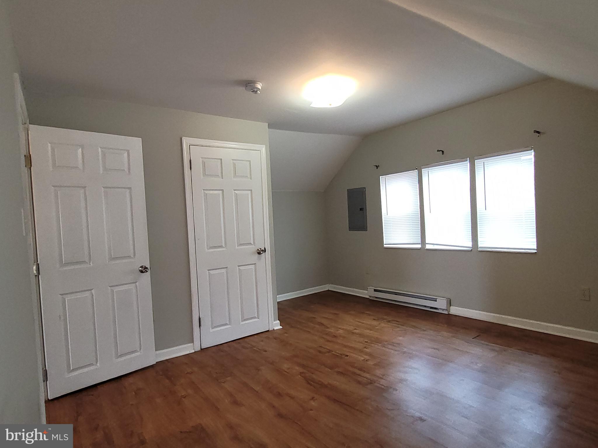 503 North Rodney Street, Unit 3A Wilmington, DE 19805 - Photo 13 of 18 an empty room with wooden floor and windows
