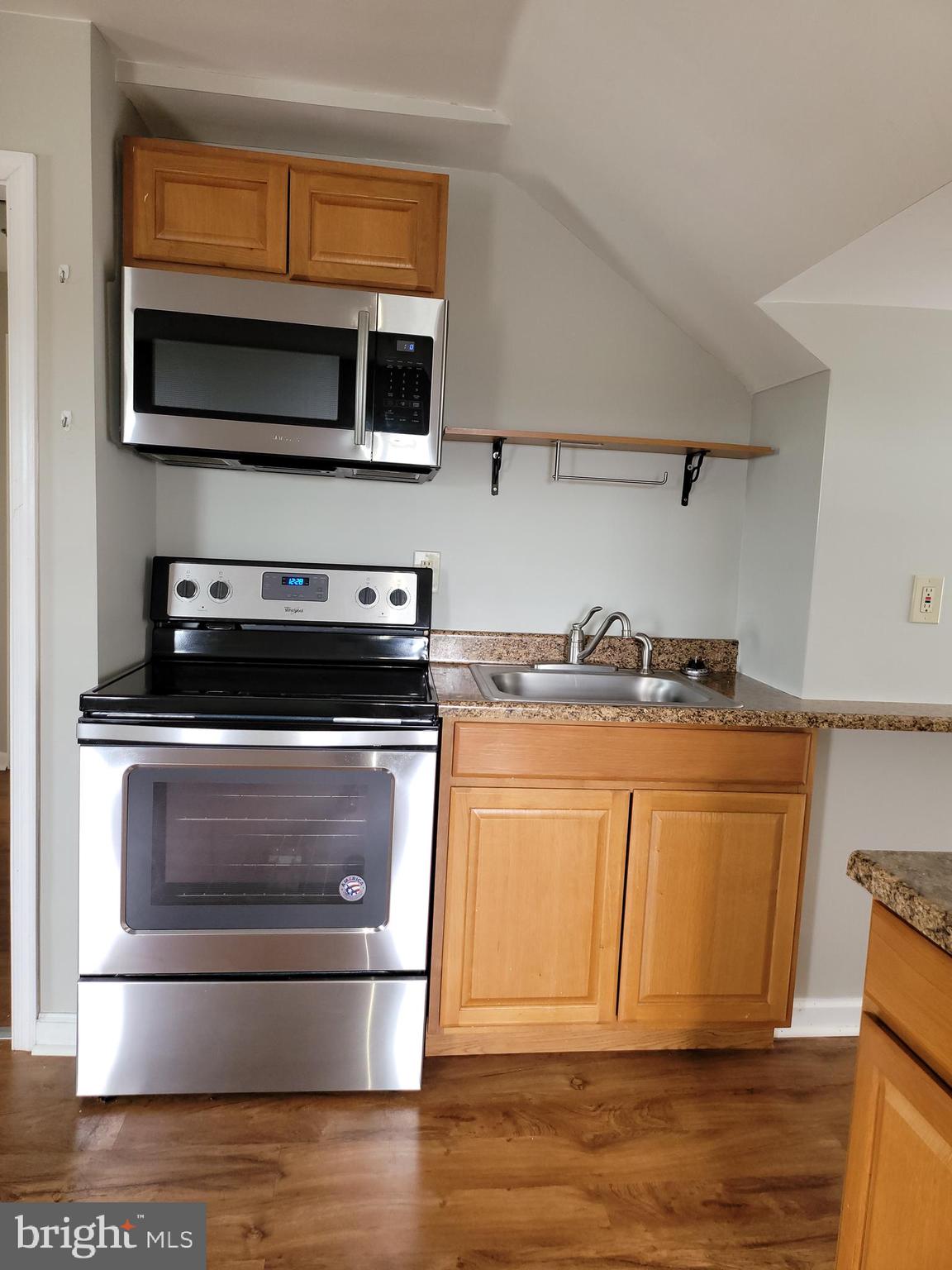 503 North Rodney Street, Unit 3A Wilmington, DE 19805 - Photo 5 of 18 a kitchen with stainless steel appliances granite countertop a stove and a microwave