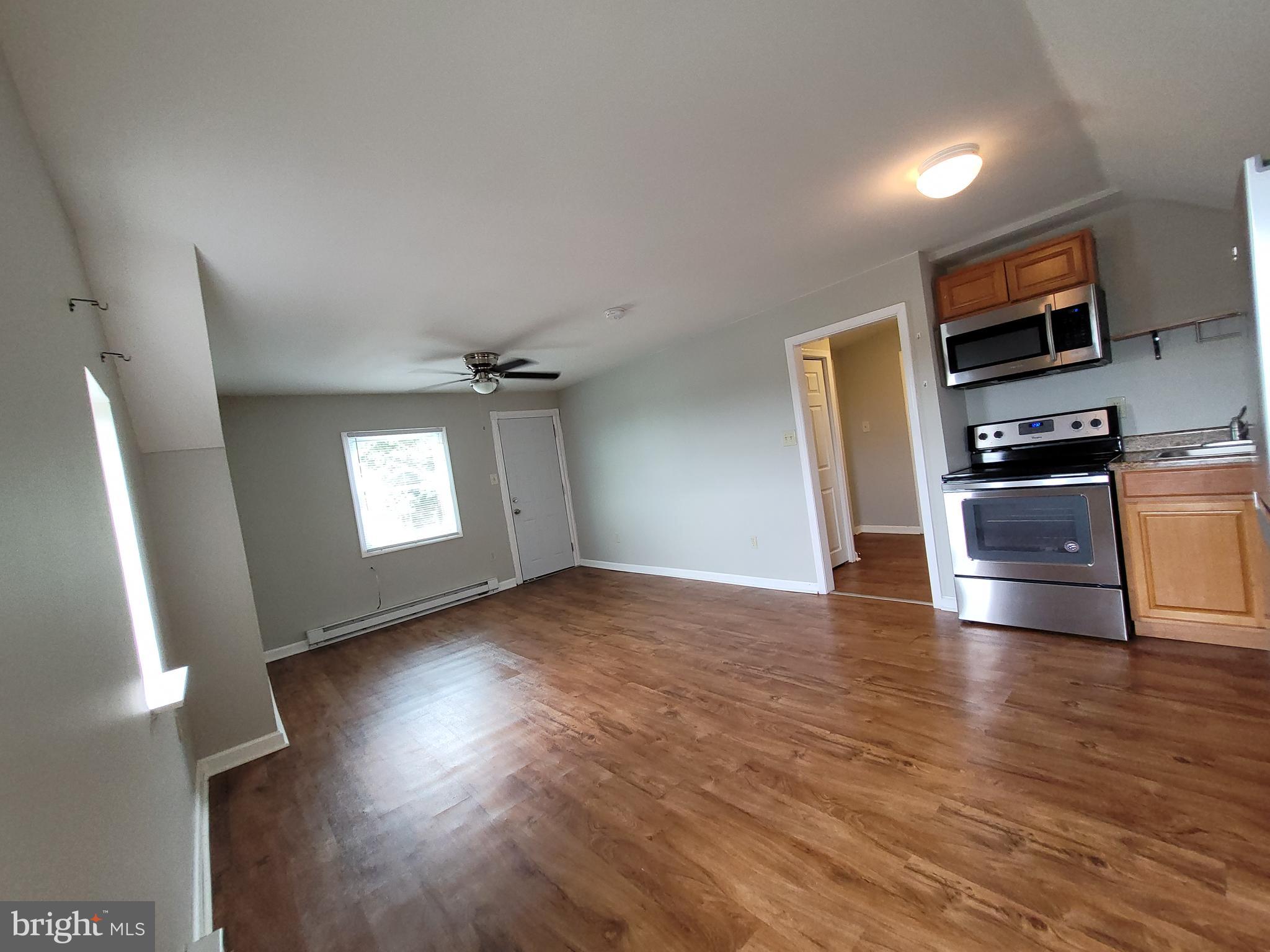 503 North Rodney Street, Unit 3A Wilmington, DE 19805 - Photo 6 of 18 a view of a kitchen with a sink stove cabinets and empty room