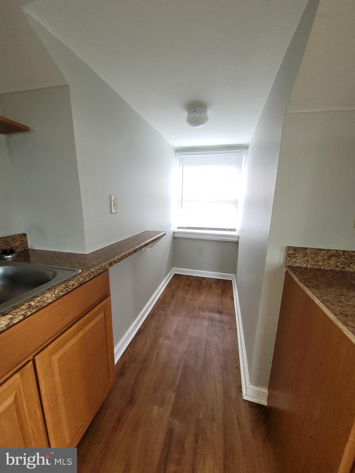 503 North Rodney Street, Unit 3A Wilmington, DE 19805 - Photo 7 of 18 a view of a kitchen with wooden floor and electronic appliances
