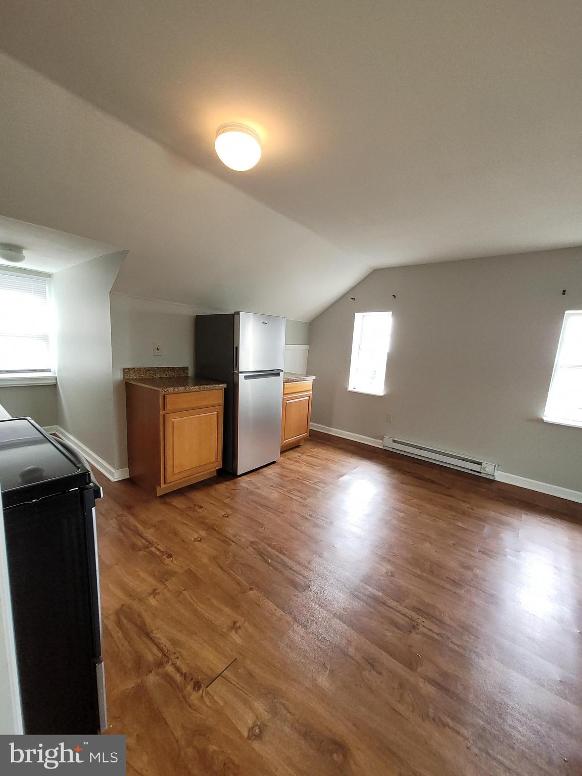 503 North Rodney Street, Unit 3A Wilmington, DE 19805 - Photo 9 of 18 a view of a livingroom with wooden floor and kitchen space