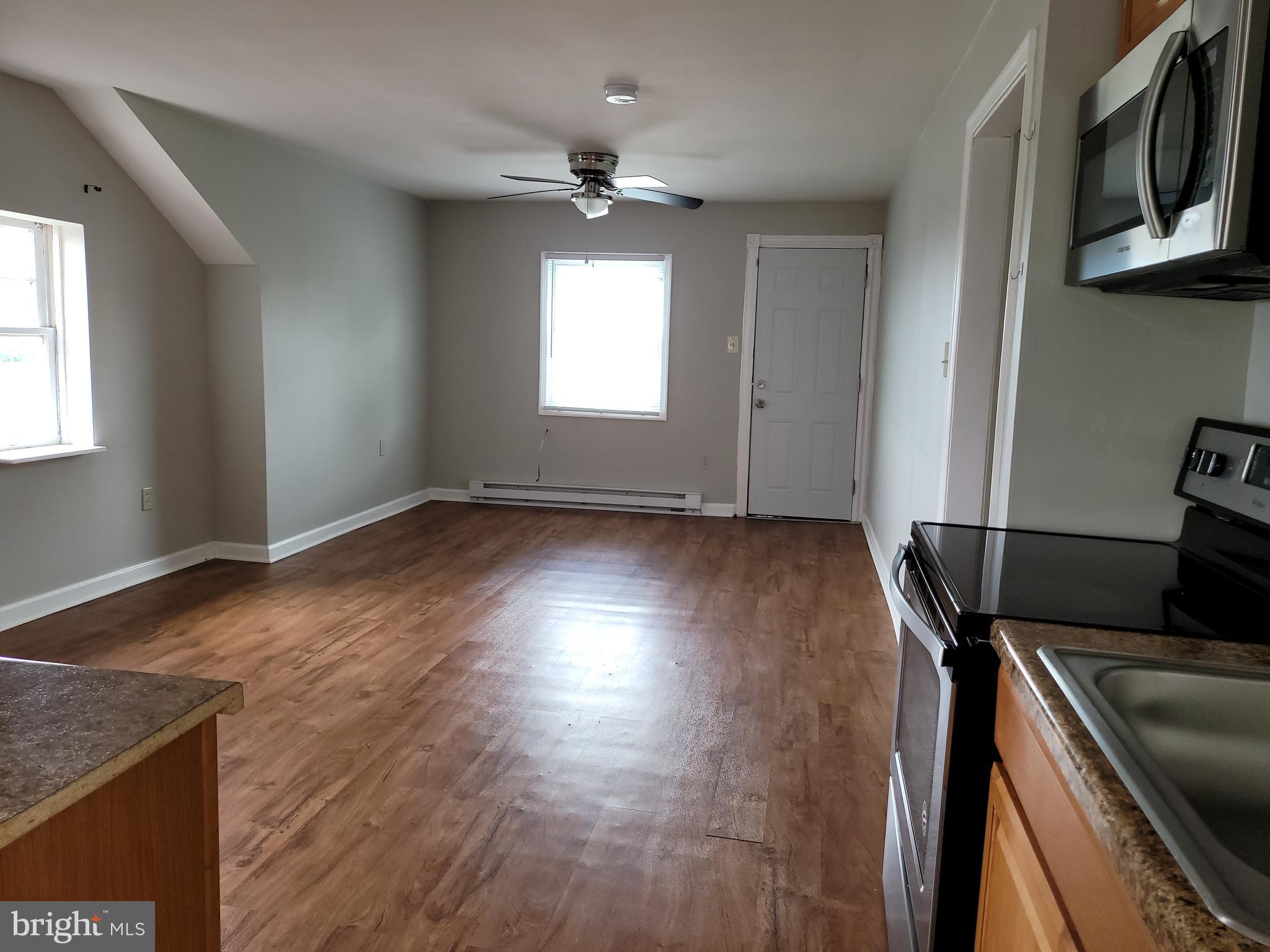 503 North Rodney Street, Unit 3A Wilmington, DE 19805 - Photo 10 of 18 a view of a room with wooden floor and windows