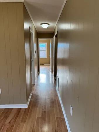 a view of a hallway with wooden floor