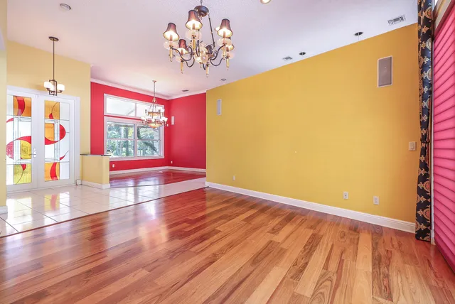 a view of an empty room with furniture and a window
