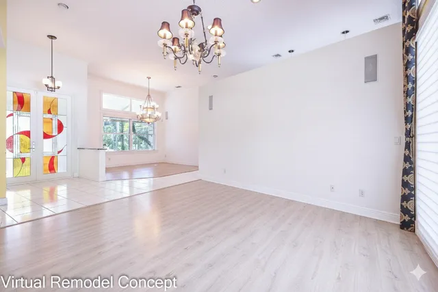 a view of an empty room with a window and storage