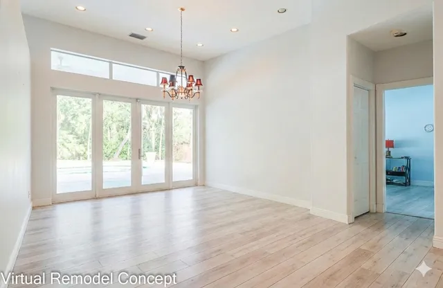 a kitchen with stainless steel appliances kitchen island granite countertop a refrigerator and a sink