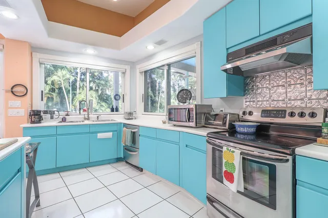 a utility room with cabinets washer and dryer