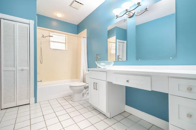 a large bathroom with a large tub shower and sink