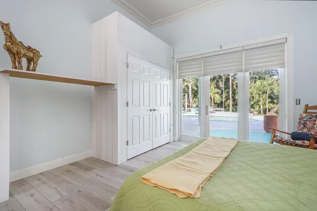 an aerial view of residential houses with outdoor space and trees