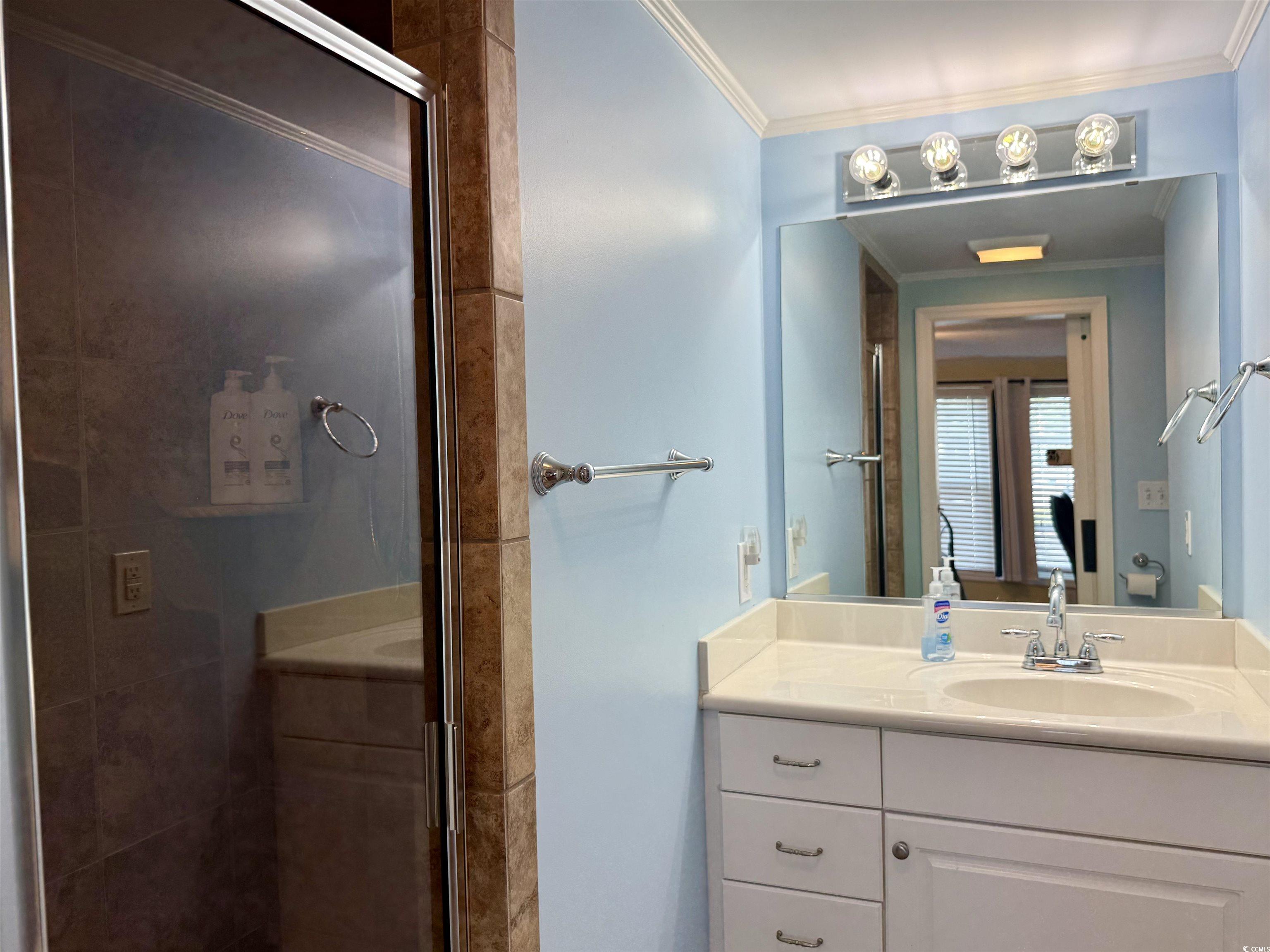 416 Oceanside Drive Surfside Beach, SC 29575 - Photo 11 of 37 Full bath featuring vanity, crown molding, and a shower stall