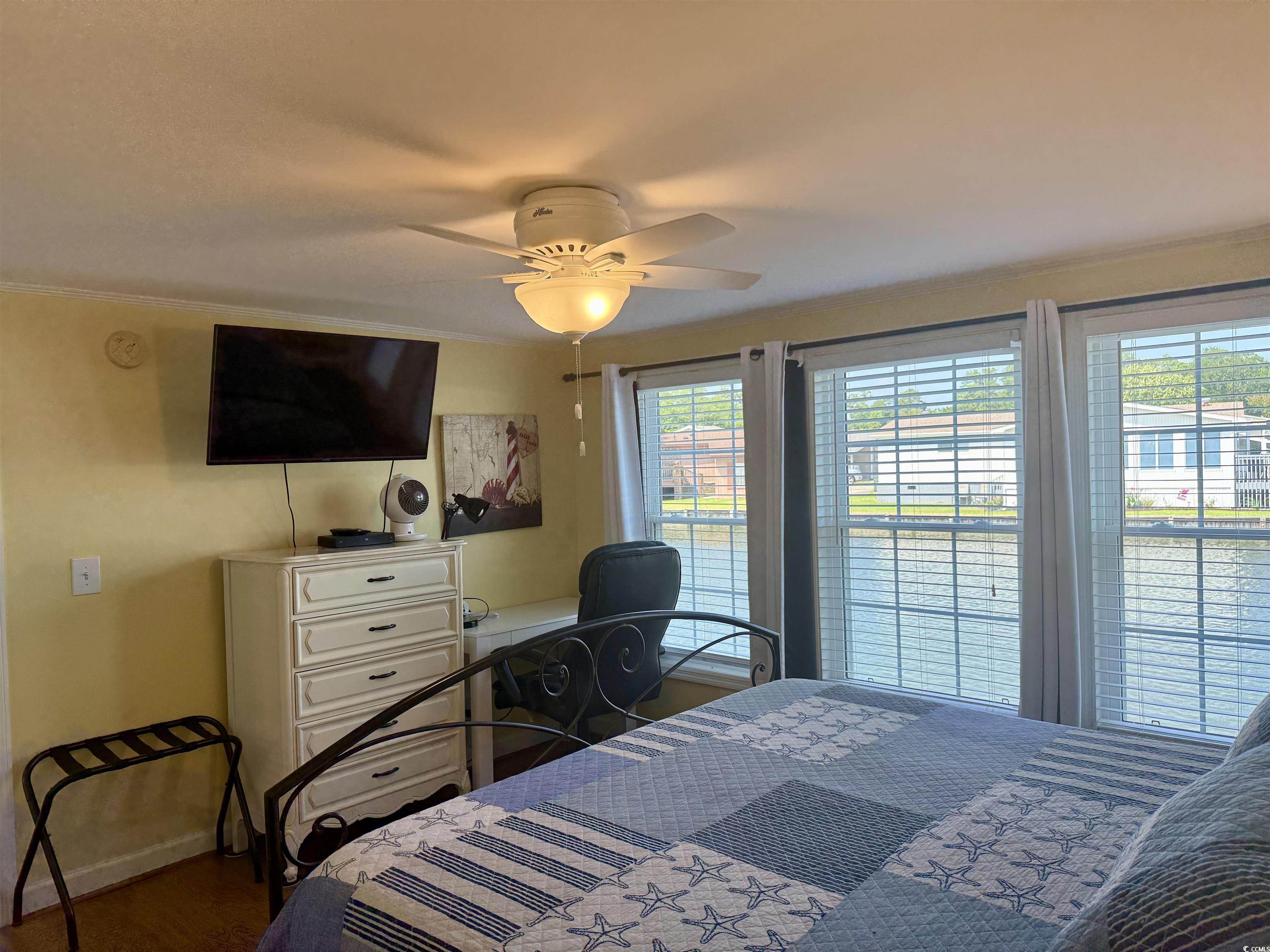 416 Oceanside Drive Surfside Beach, SC 29575 - Photo 13 of 37 Bedroom featuring multiple windows, ceiling fan, crown molding, and wood finished floors