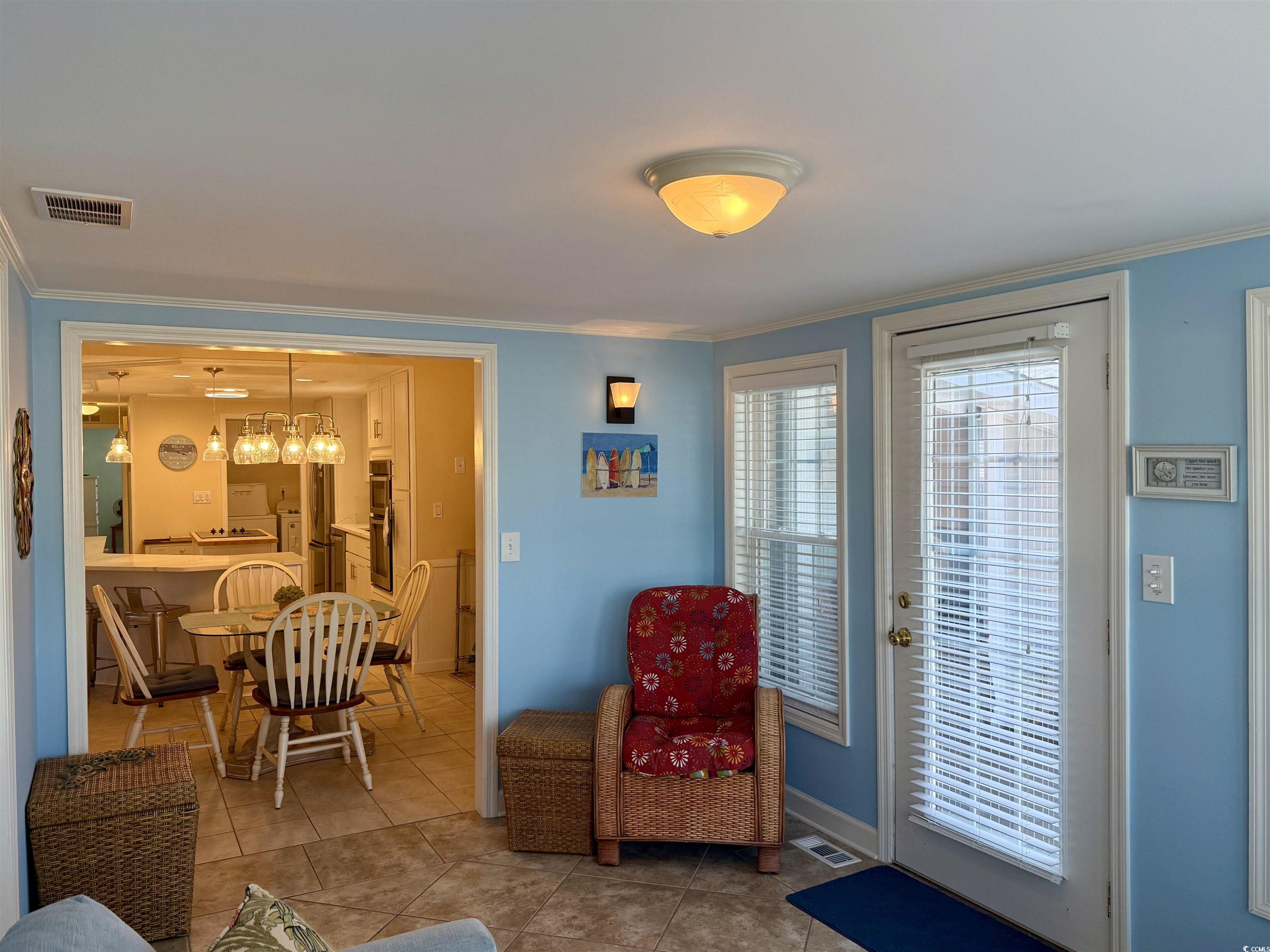 416 Oceanside Drive Surfside Beach, SC 29575 - Photo 15 of 37 Living room featuring ornamental molding and light tile patterned floors