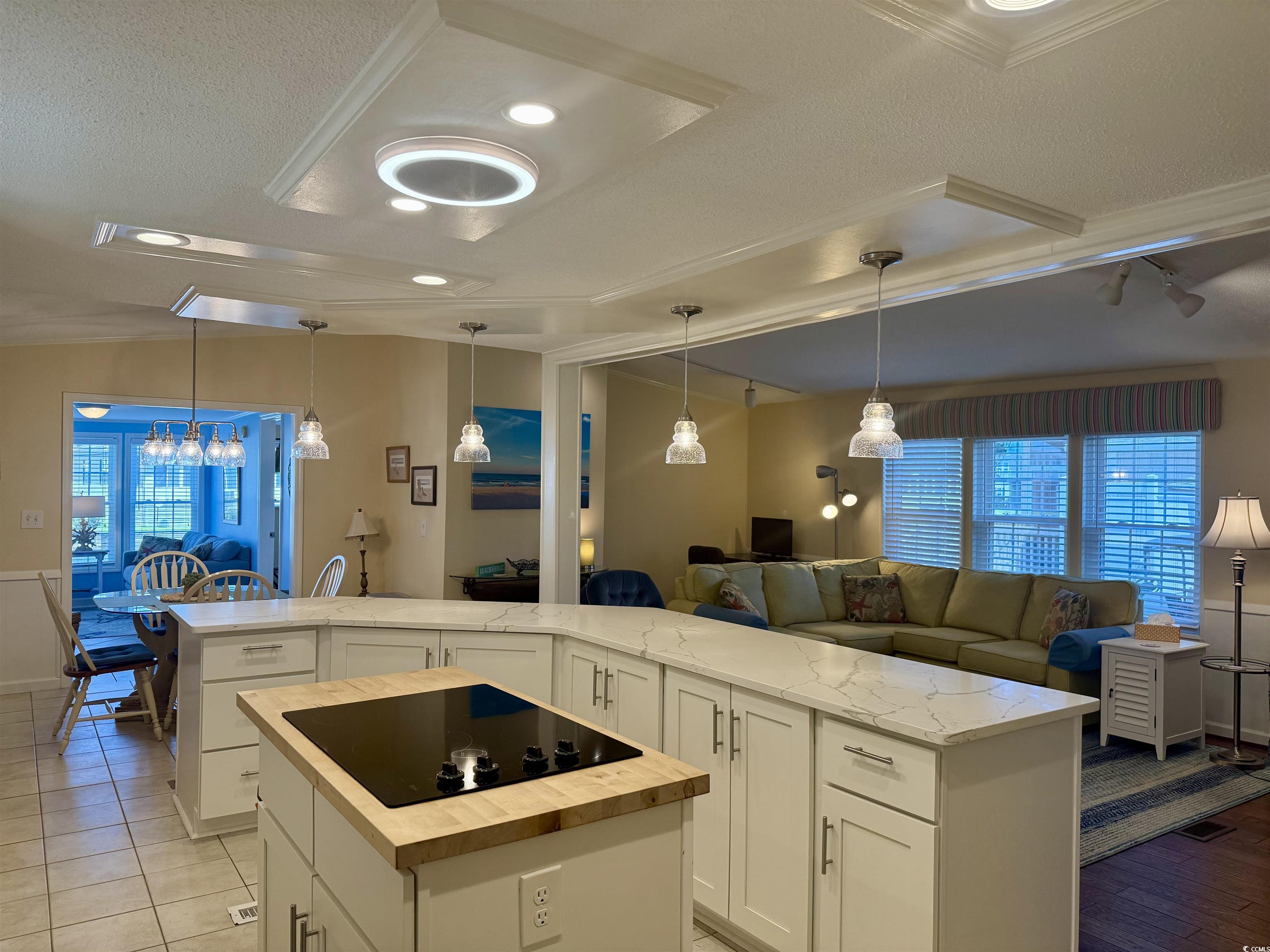 416 Oceanside Drive Surfside Beach, SC 29575 - Photo 37 of 37 Kitchen with black electric cooktop, wooden counters, a center island, open floor plan, and plenty of natural light