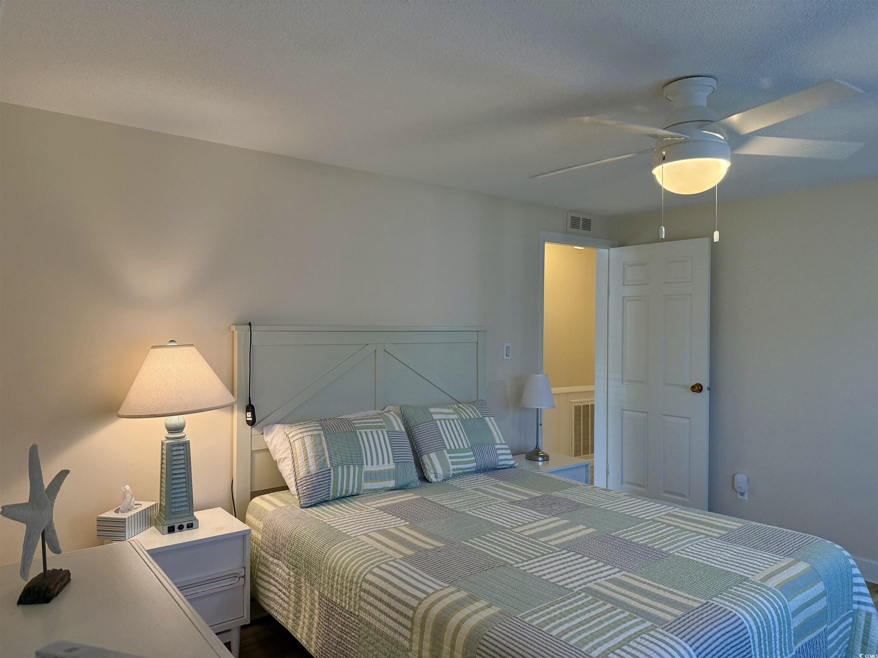 416 Oceanside Drive Surfside Beach, SC 29575 - Photo 21 of 37 Bedroom with a ceiling fan and carpet flooring