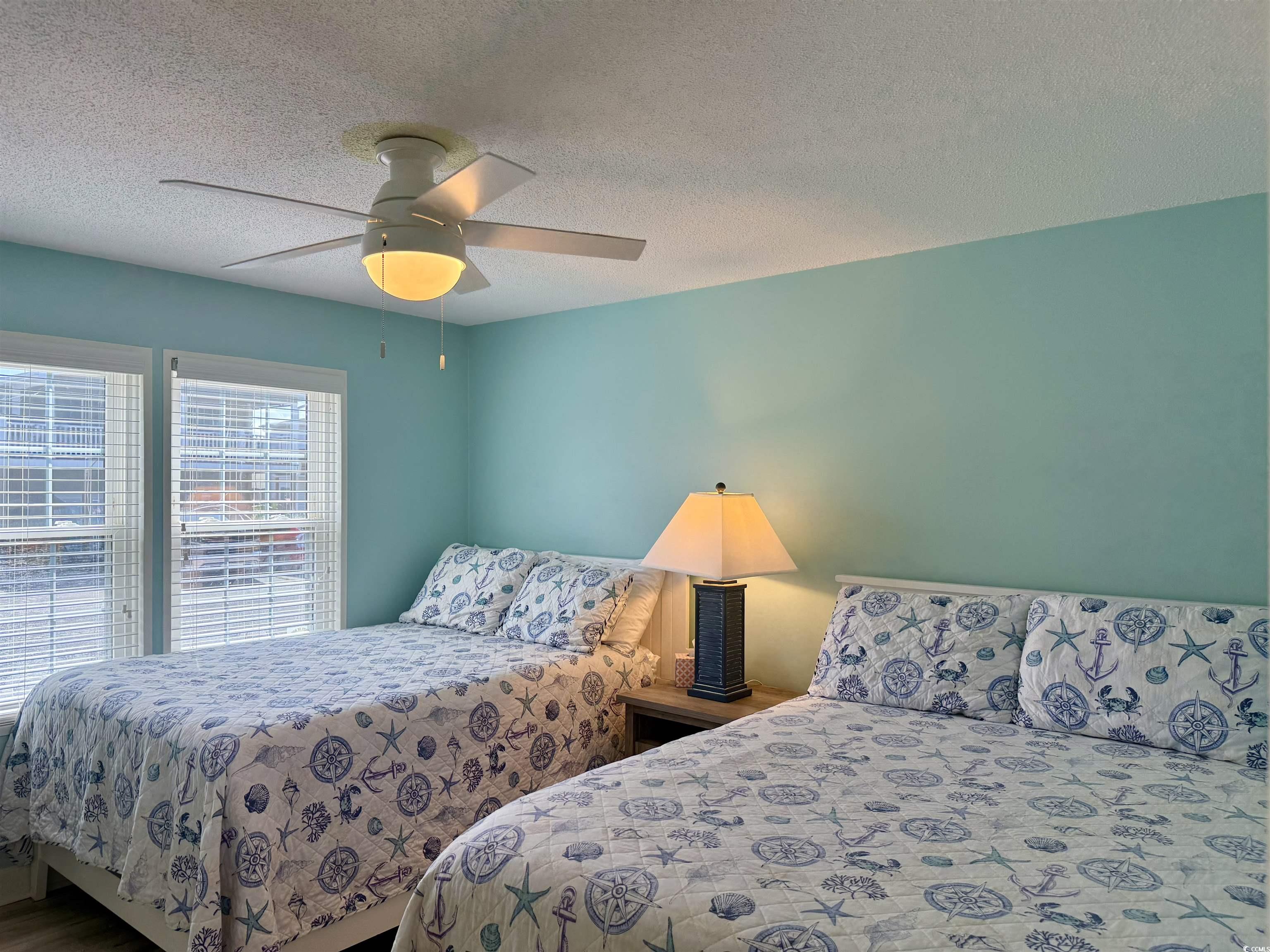 416 Oceanside Drive Surfside Beach, SC 29575 - Photo 23 of 37 Bedroom with a textured ceiling and ceiling fan