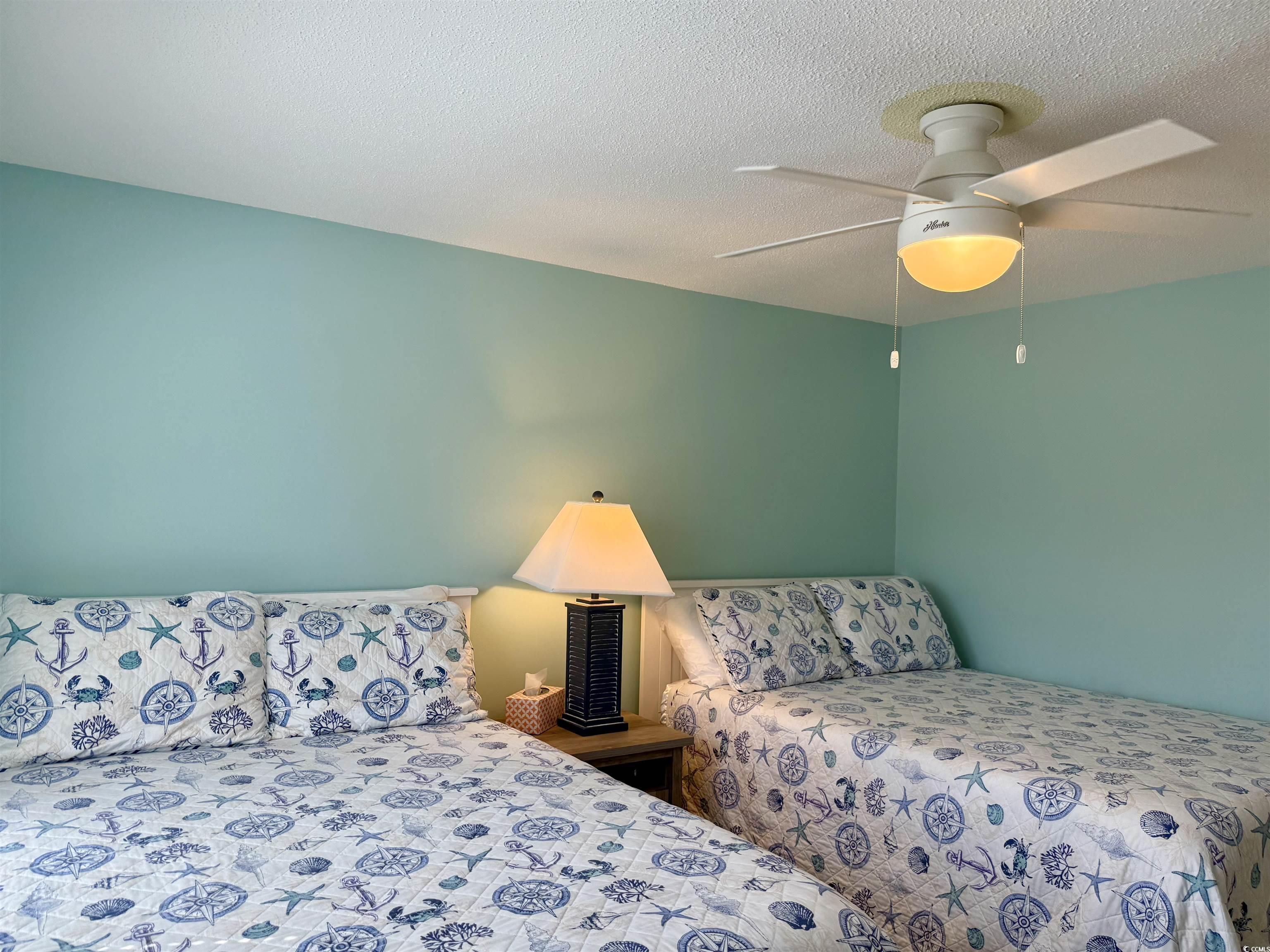 416 Oceanside Drive Surfside Beach, SC 29575 - Photo 24 of 37 Bedroom featuring a textured ceiling and a ceiling fan