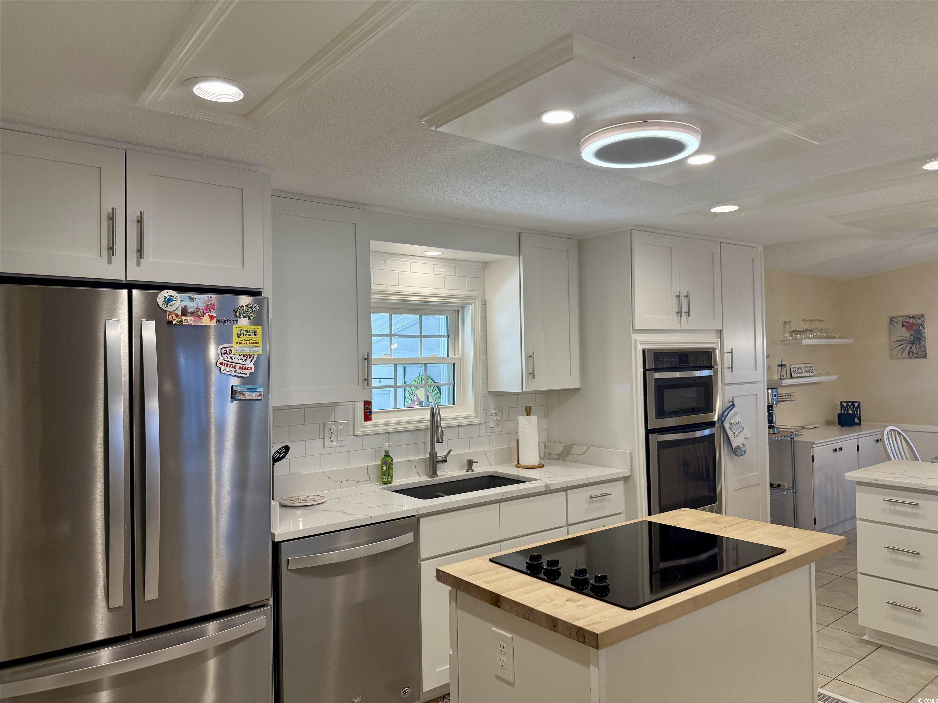 416 Oceanside Drive Surfside Beach, SC 29575 - Photo 2 of 37 Kitchen featuring appliances with stainless steel finishes, wood counters, recessed lighting, tasteful backsplash, and a kitchen island