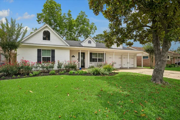 a front view of house with yard and green space