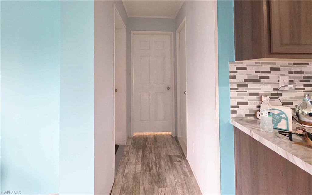 612 Hunting Clb Avenue Montura Ranches, FL 33440 - Photo 31 of 49 a view of a hallway with wooden floor