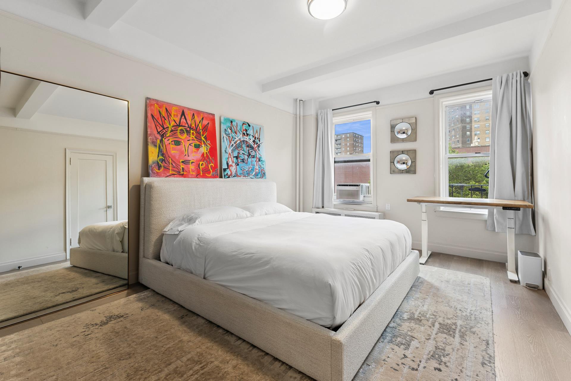 172 East 4th Street, Unit 6C Manhattan, NY 10009 - Photo 3 of 7 a bedroom with a large bed and a window