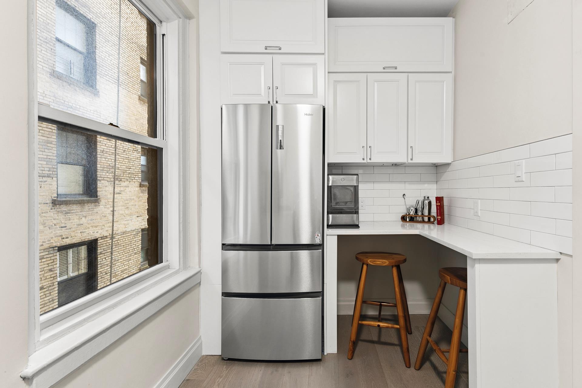 172 East 4th Street, Unit 6C Manhattan, NY 10009 - Photo 6 of 7 a kitchen with stainless steel appliances granite countertop a refrigerator and a stove top oven