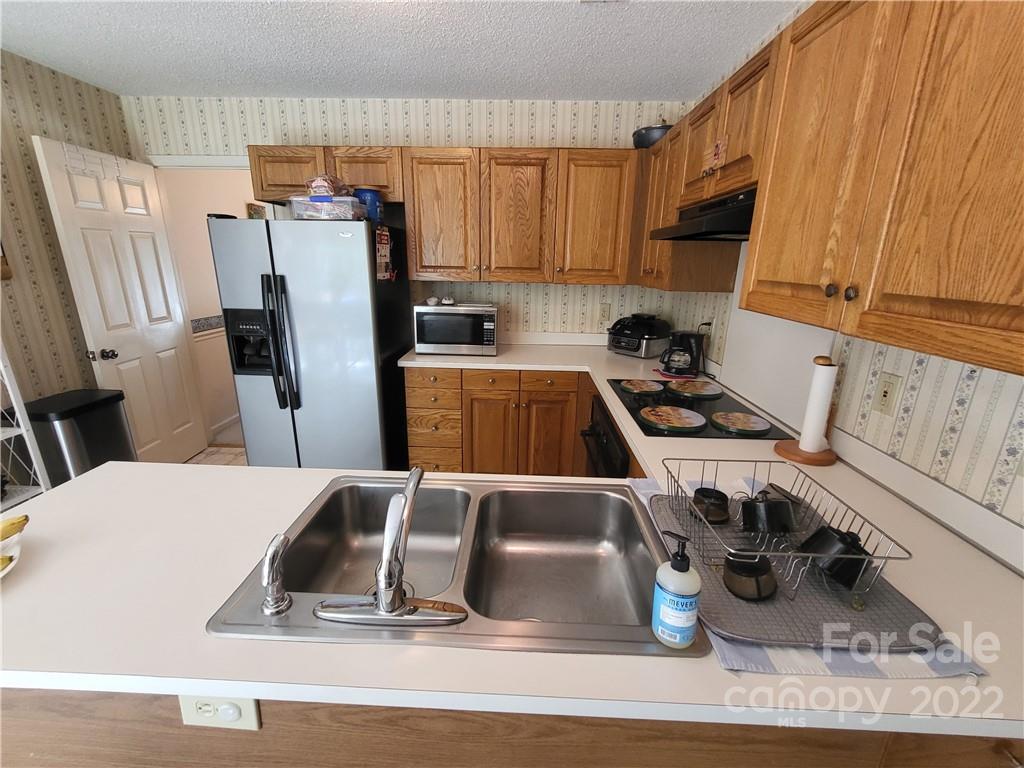 9216 Torrence Crossing Drive Huntersville, NC 28078 - Photo 19 of 34 a kitchen with a refrigerator and a sink